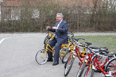 Es stimmt schon: Der Minister ist flexibel und nimmt Platz auf dem kleinen Fahrrad